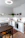 Cozy modern kitchen with light wood PVC flooring and soft natural light streaming through the window.