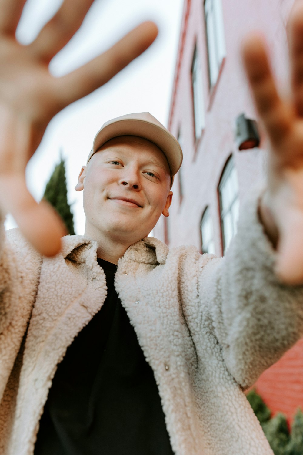 smiling boy in white coat and black hat