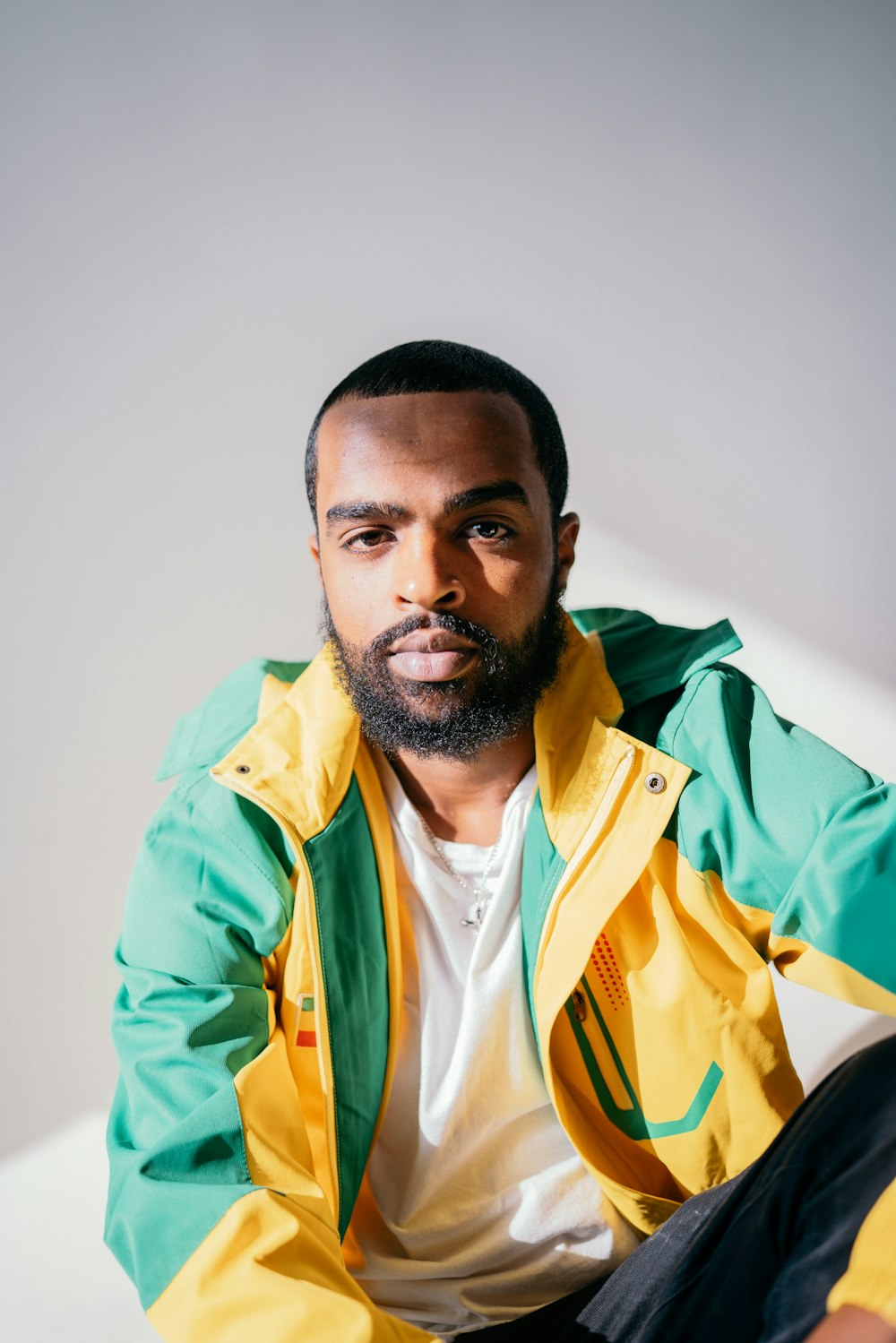 man in green and yellow zip up jacket