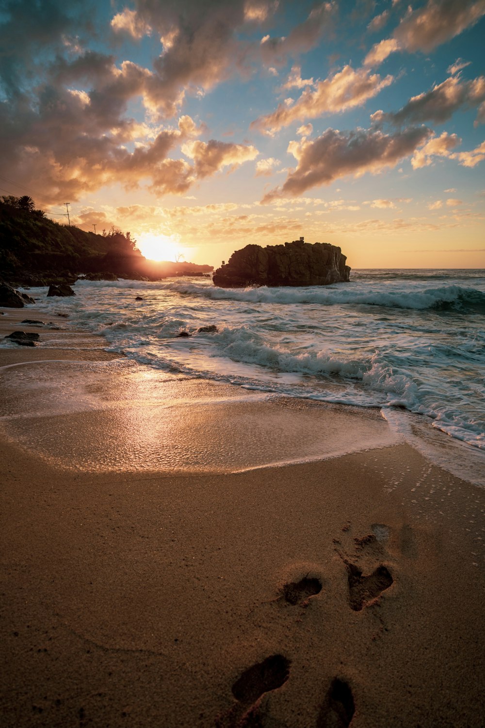 brown rock formation on sea shore during sunset