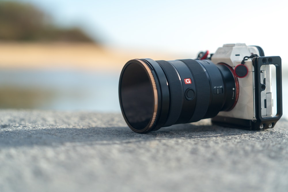 black camera lens on gray concrete floor