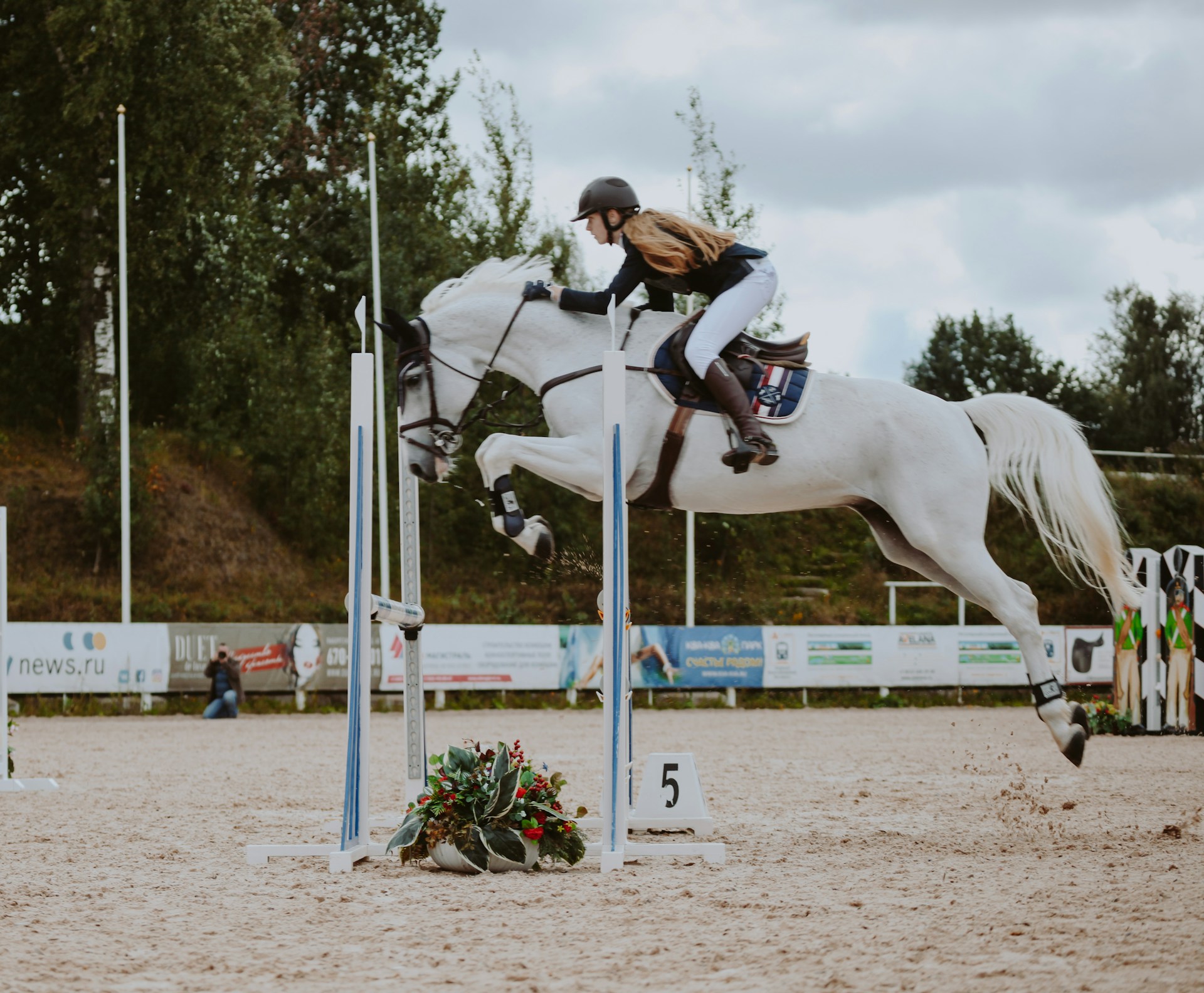 man riding white horse during daytime