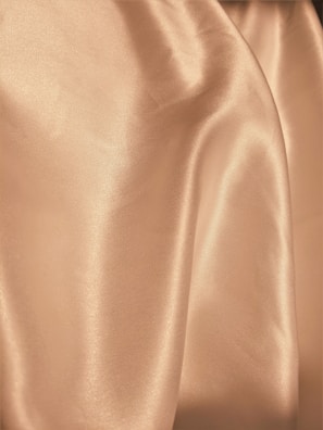 Smooth, flowing fabric with a shiny texture and soft folds, likely made of silk or satin.