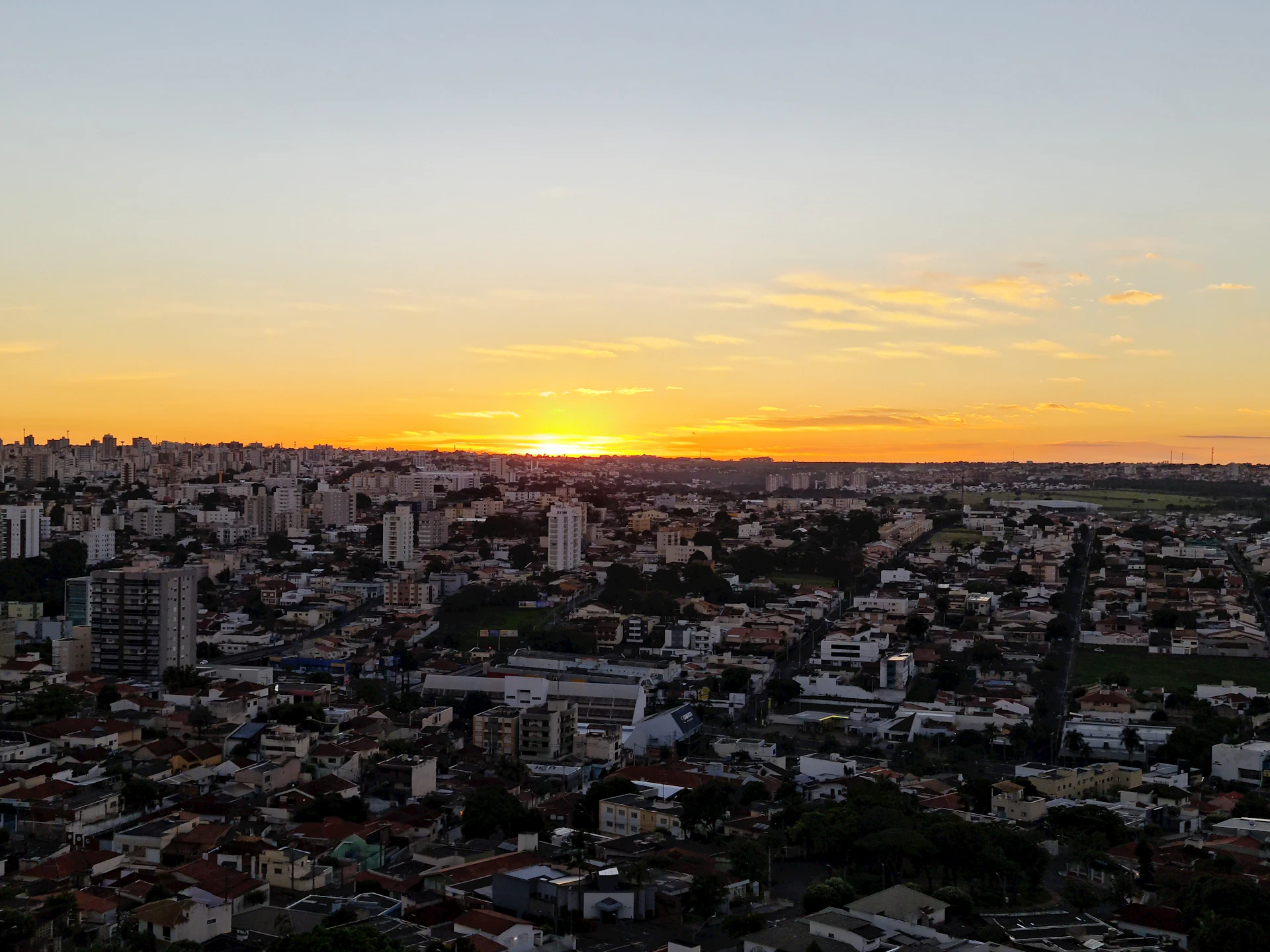 A vibrant sunset casting golden hues over a bustling cityscape captured during a private photo tour.