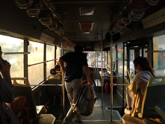 Passengers boarding a comfortable bus operated by Gustavo Silva Candizani on a sunny day