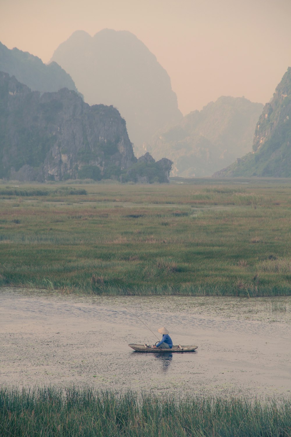 person riding on boat on green grass field during daytime