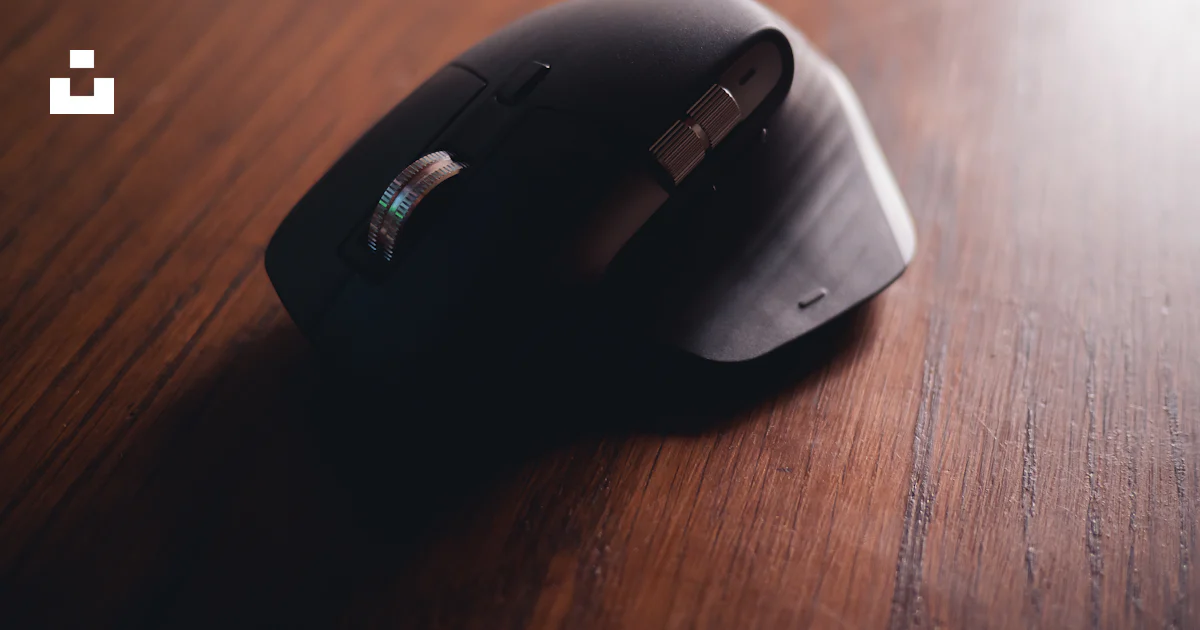Black cordless computer mouse on brown wooden table photo – Free Mouse ...
