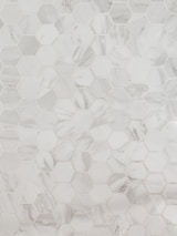 A pattern of hexagonal marble tiles with varying shades of white and grey, creating a geometric and elegant design.