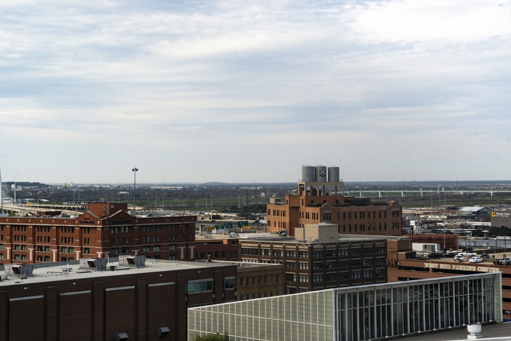 brown and white concrete buildings under white clouds during daytime