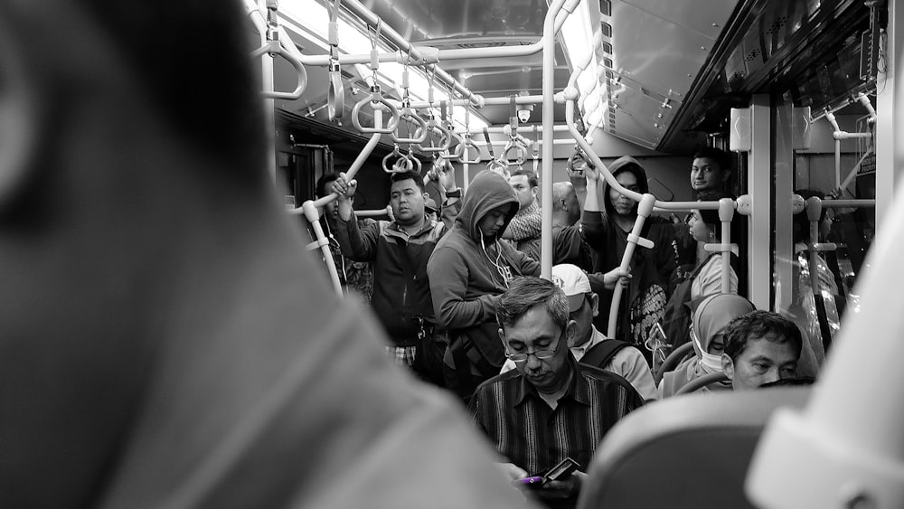 grayscale photo of people in train