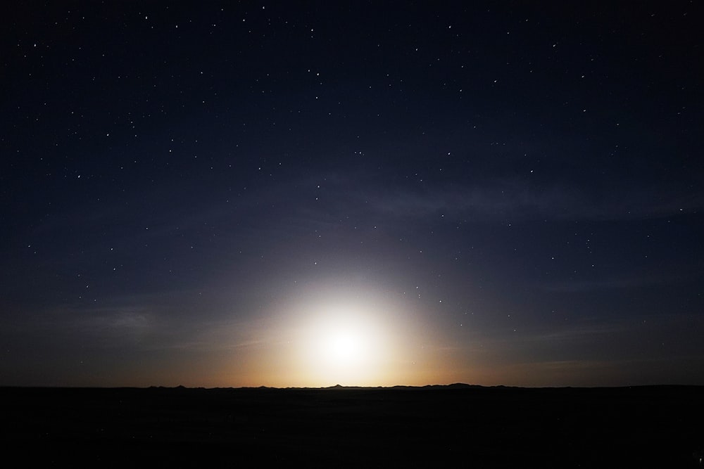 silhouette of mountain during night time