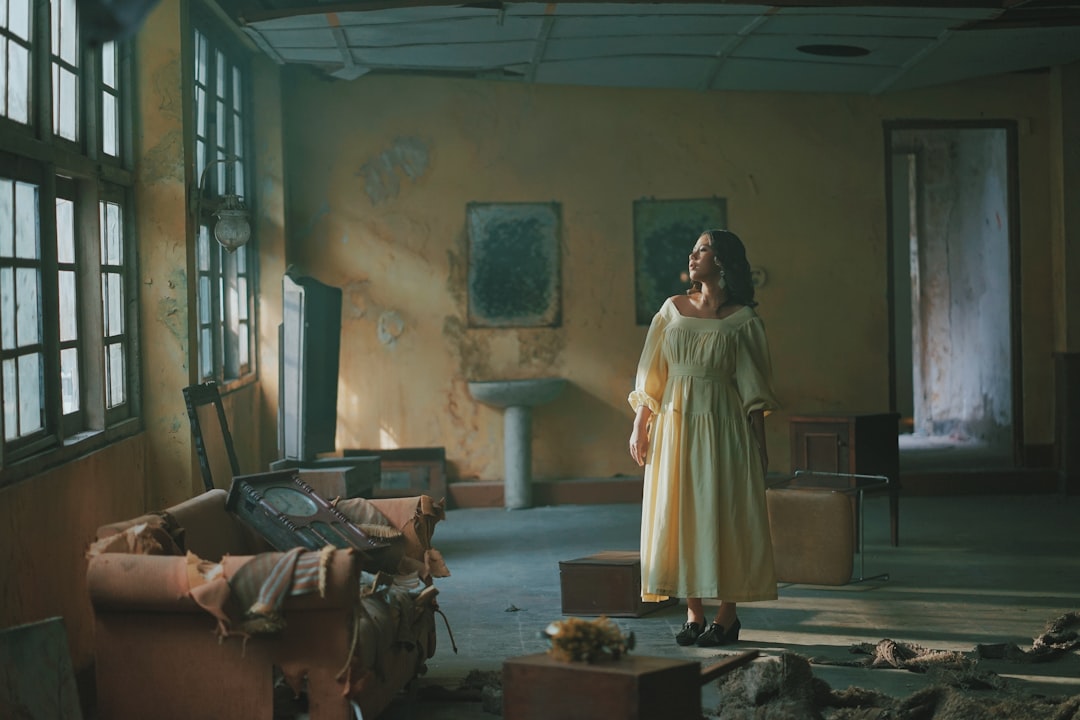 woman in white dress standing beside brown wooden table