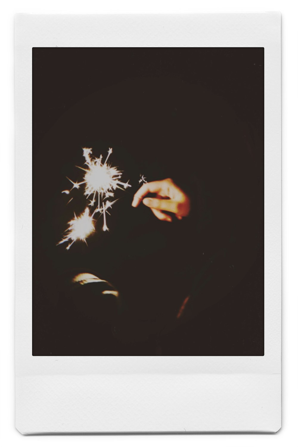 person holding white fireworks during nighttime