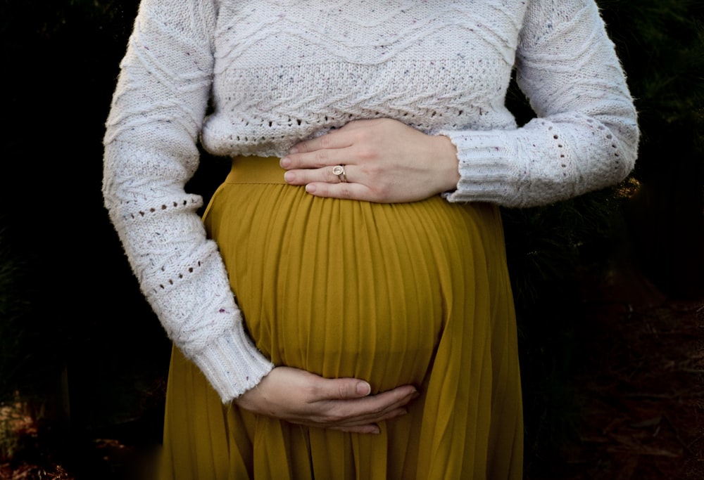 woman in white long sleeve shirt and yellow skirt