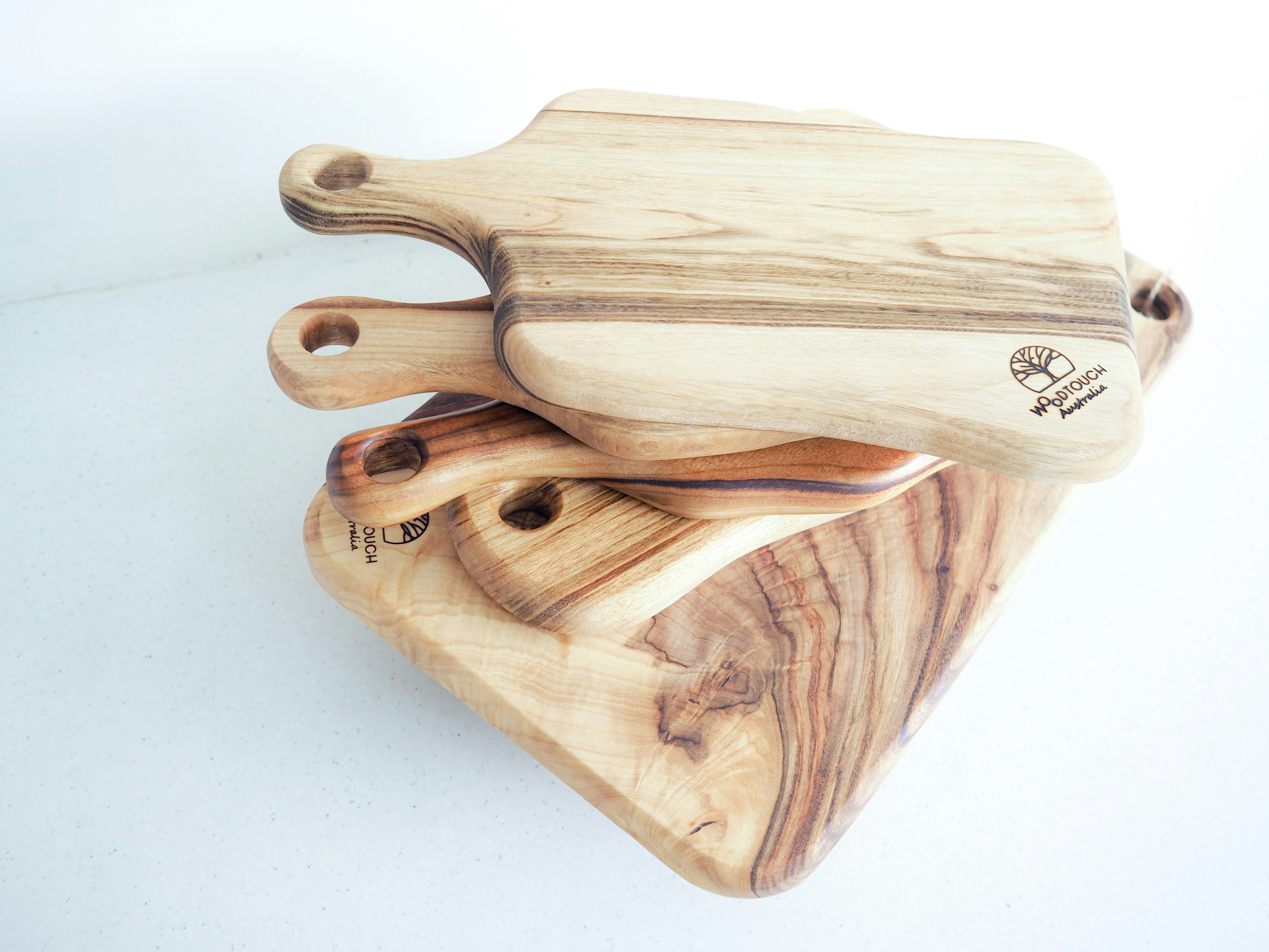 Bamboo cutting boards stacked on kitchen counter, natural wood tones