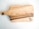 A wooden cutting board with natural wood grain patterns, highlighting darker and lighter streaks. The board has a handle with a hole for hanging. A logo with the text 'WOODTOUCH Australia' is engraved in one corner.