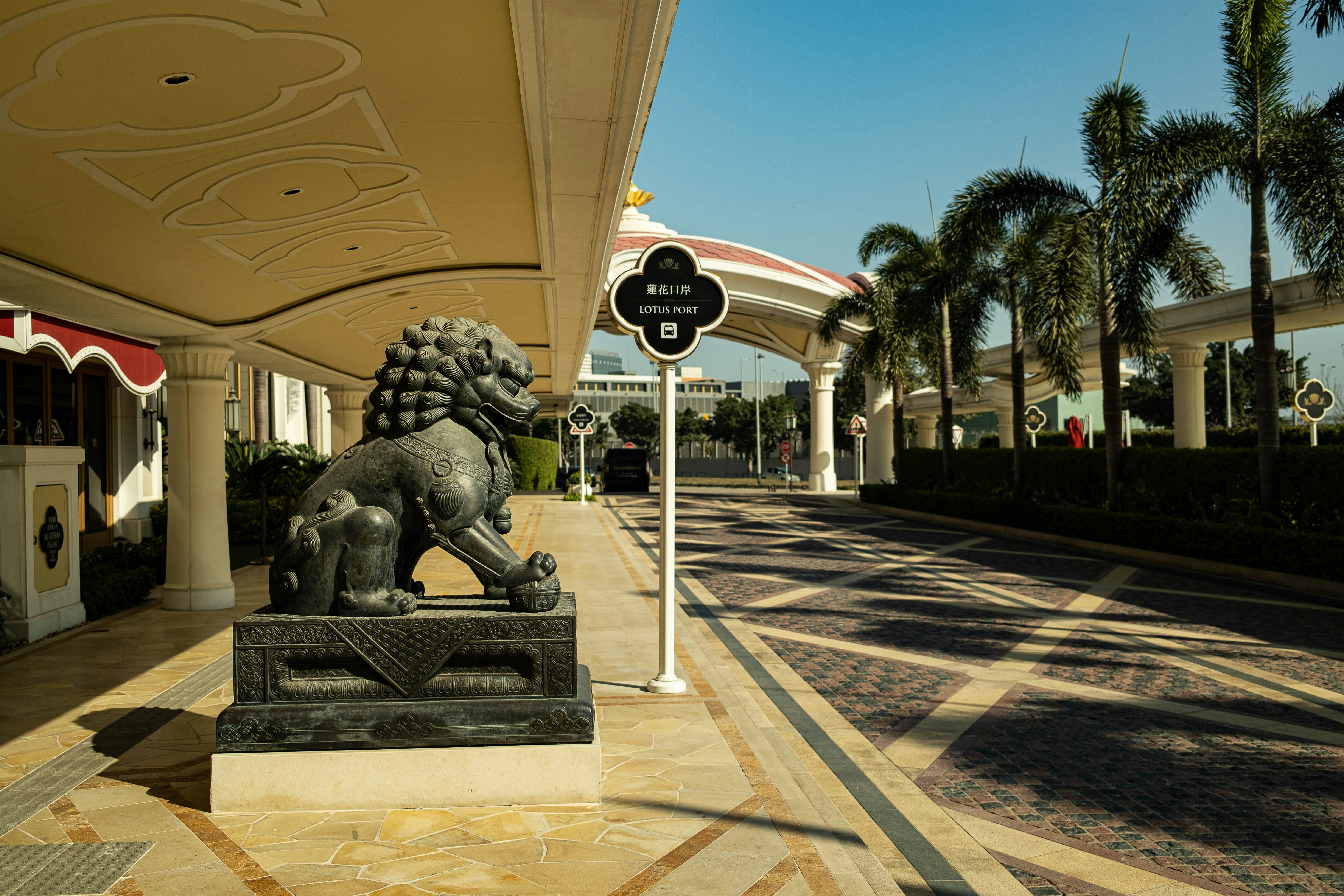 black statue of man sitting on bench