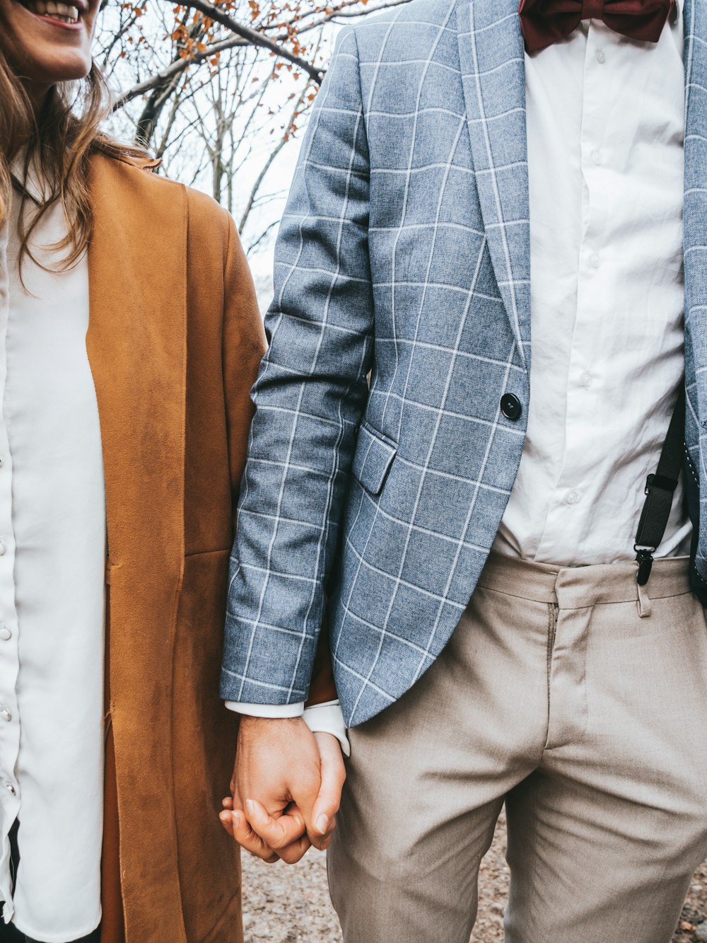 man in gray suit jacket and woman in white dress shirt