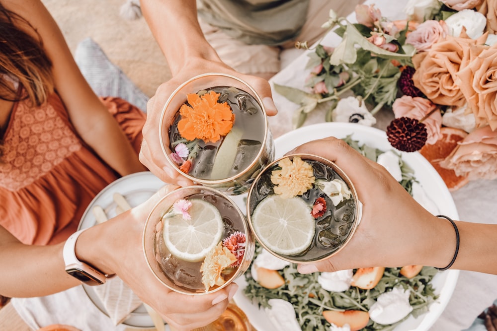 person holding white ceramic bowl with fruits