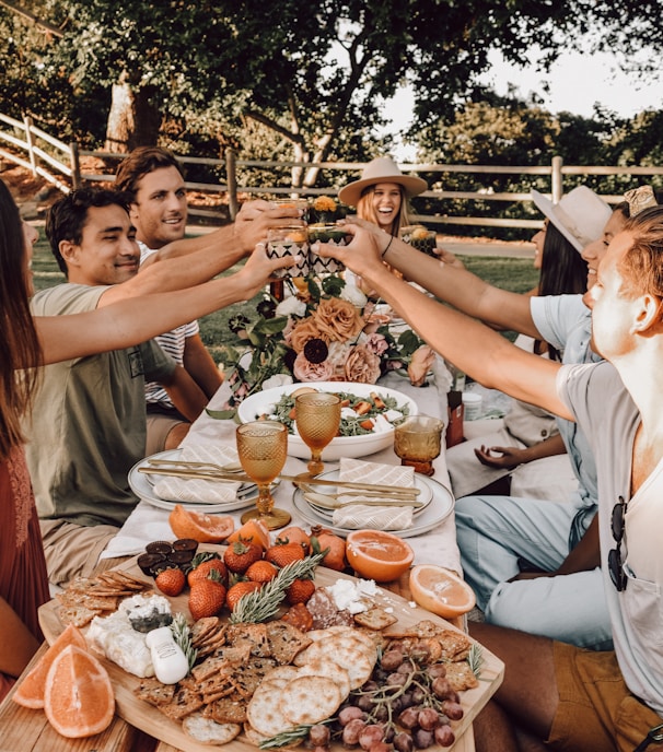 people sitting on chair eating food during daytime