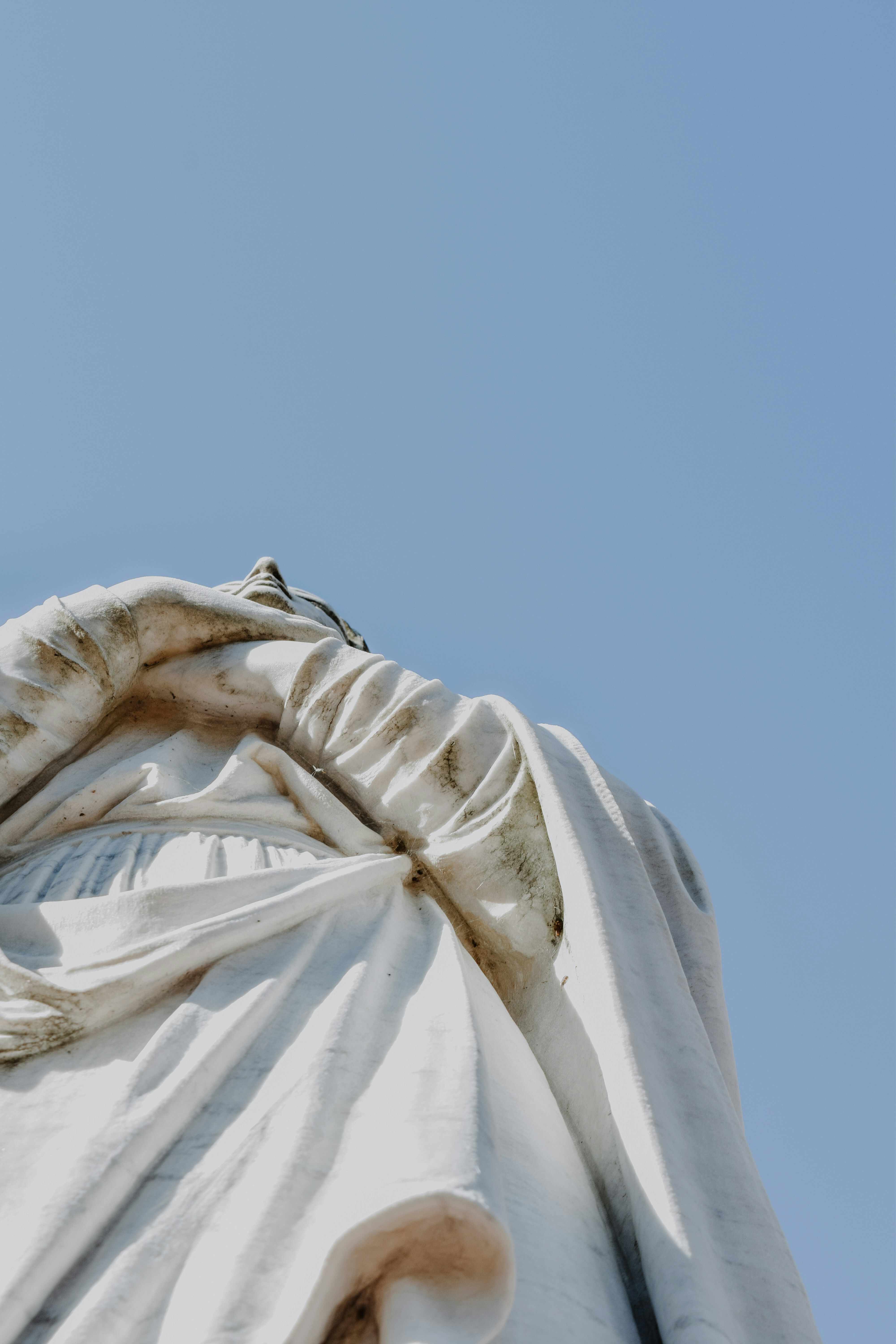white angel statue under blue sky during daytime