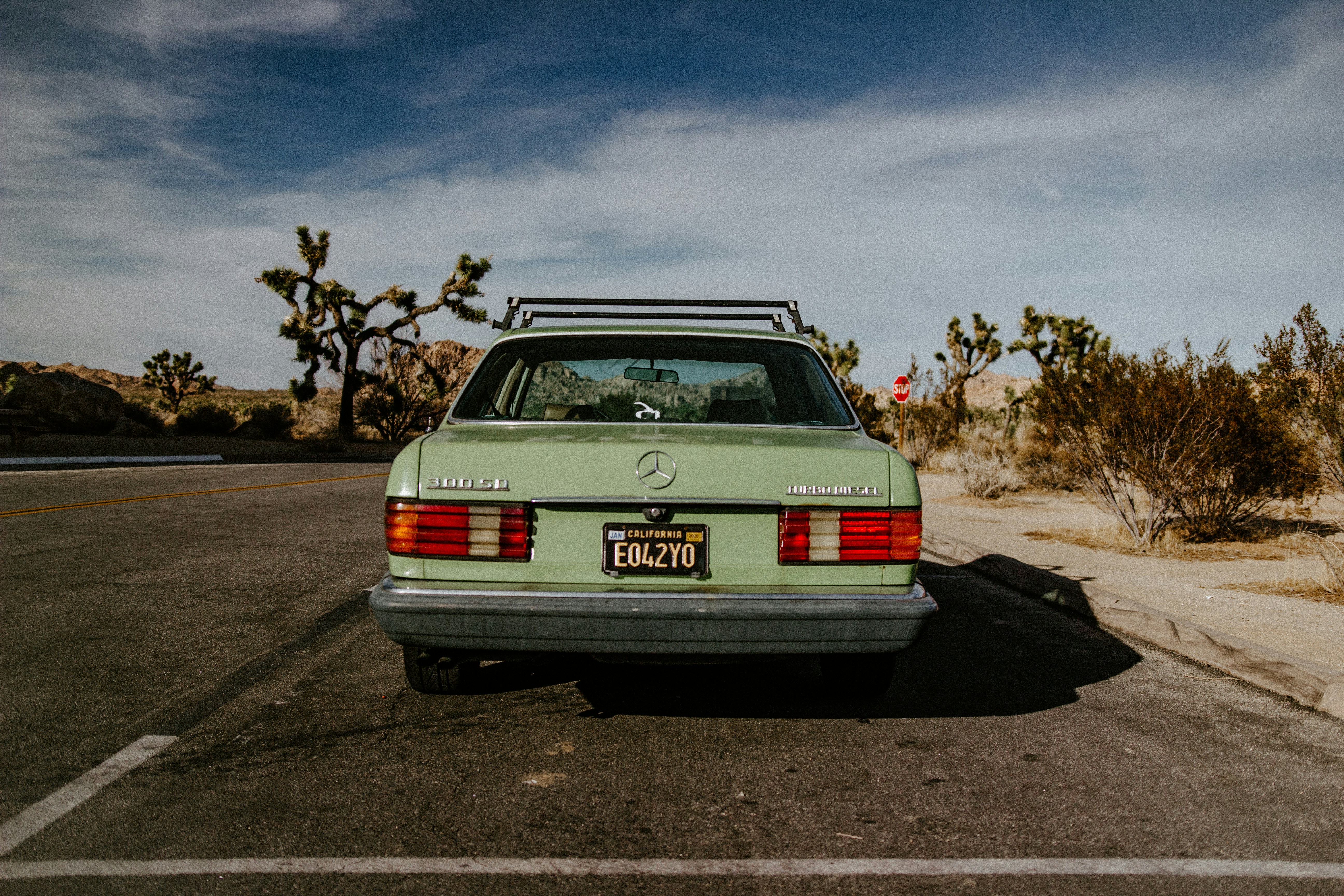 green car on road during daytime