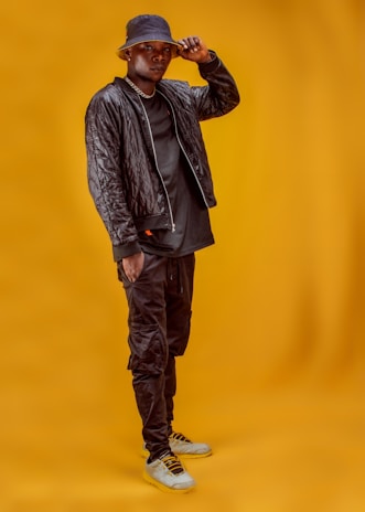 A close-up of a person confidently wearing a bold, stylish jacket from the flyest survivor collection.