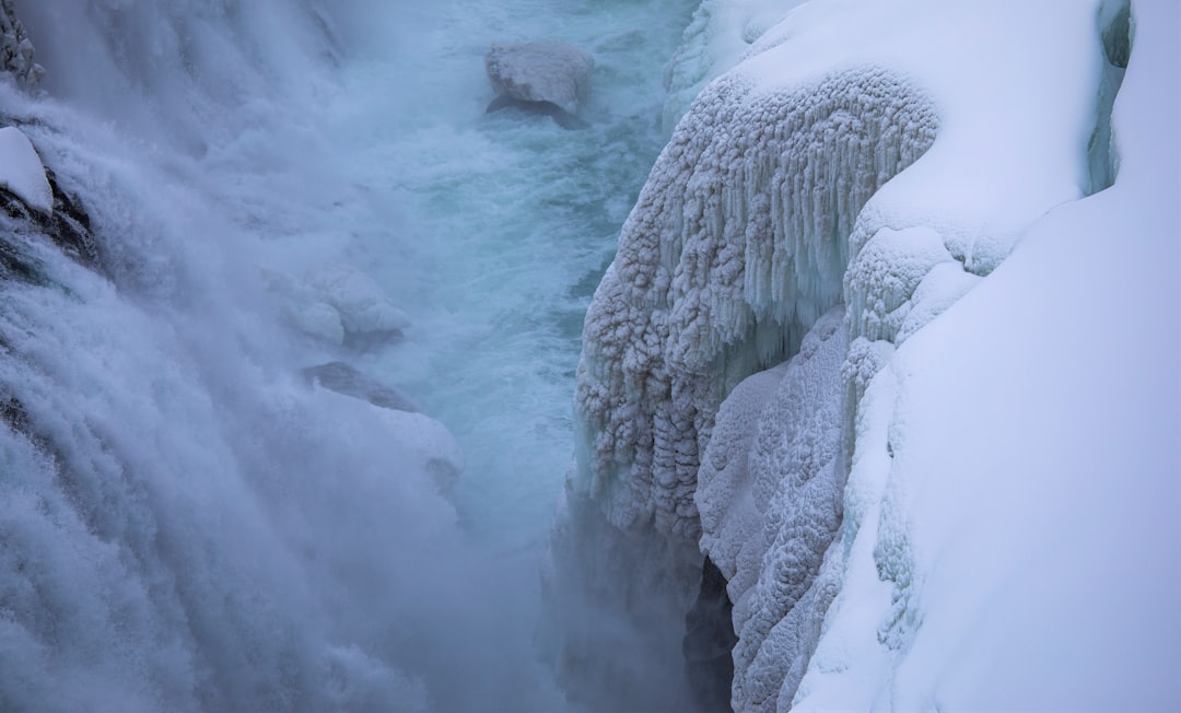 white ice on body of water