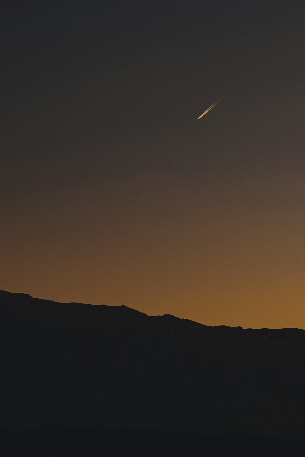 silhouette of mountain during sunset