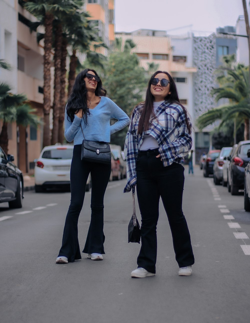 2 women standing on road during daytime