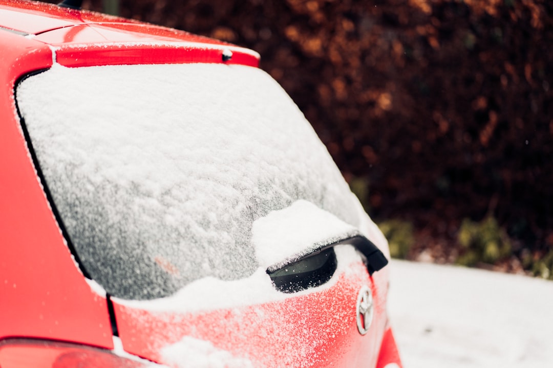 red and white car with snow on top