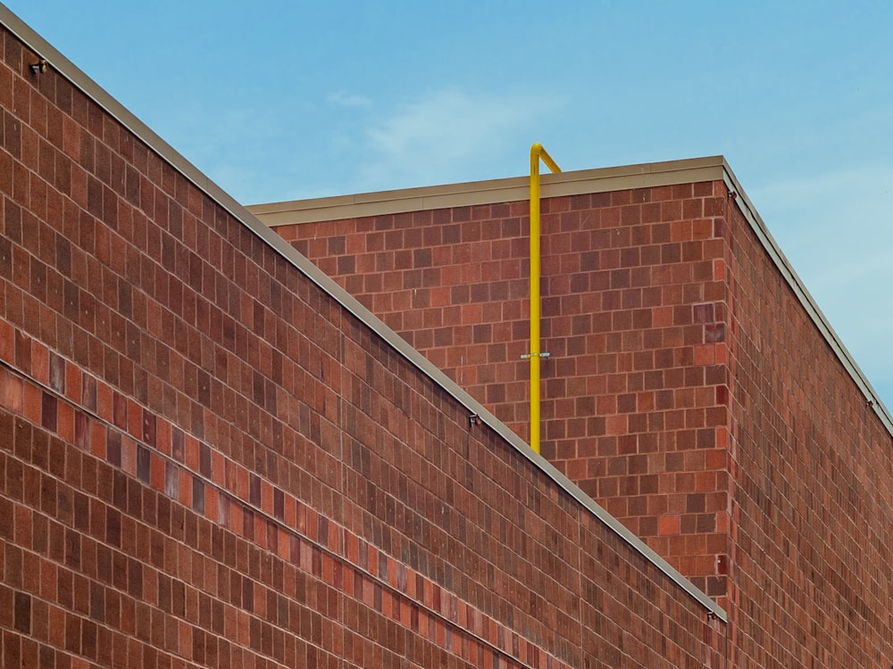 brown brick wall under blue sky during daytime