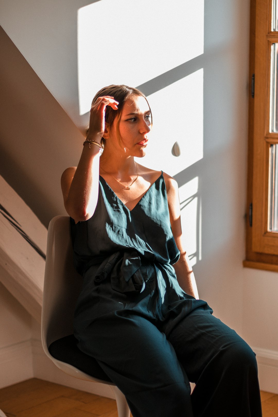 woman in blue denim vest and blue denim jeans sitting on white couch