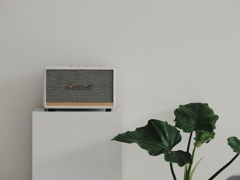 silver and black rectangular device on white wall