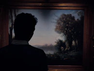 A gentle moment of reflection as Randy steps back to view a nearly finished charcoal-accented piece.