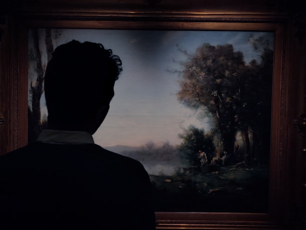 Close-up of an elegant wooden frame surrounding a vibrant landscape painting.