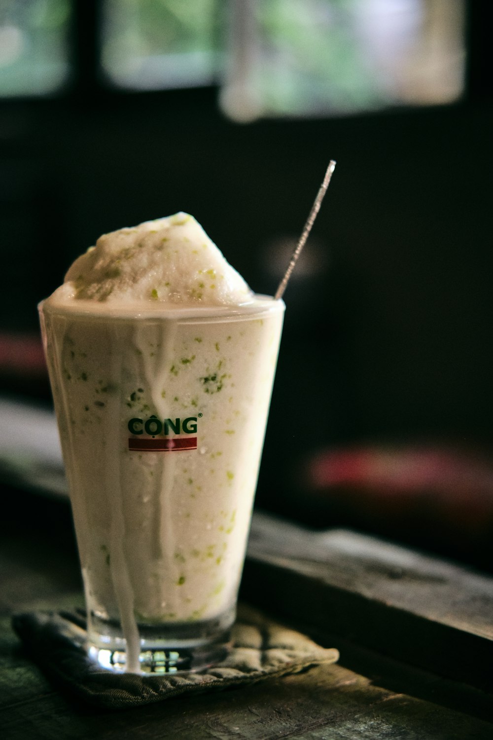 white and brown ice cream in clear plastic cup