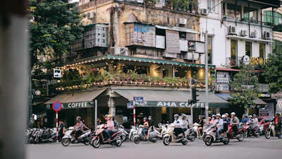 people riding motorcycle on road near building during daytime