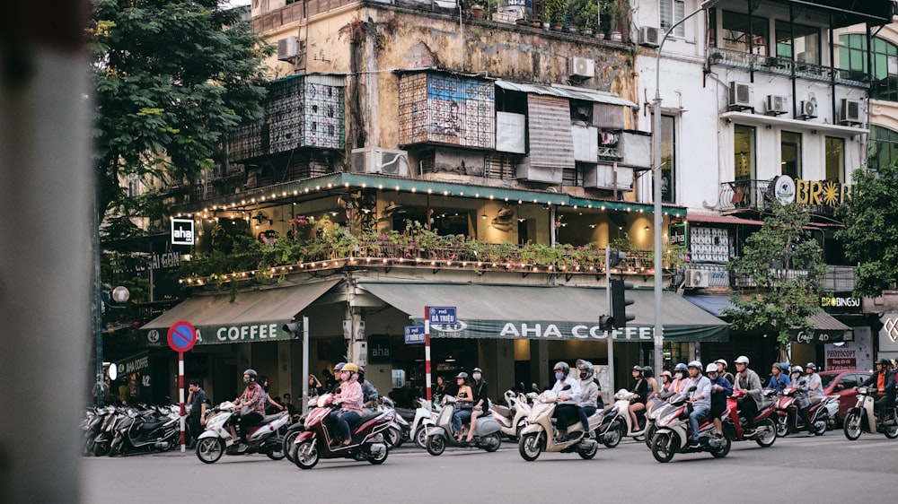 people riding motorcycle on road near building during daytime