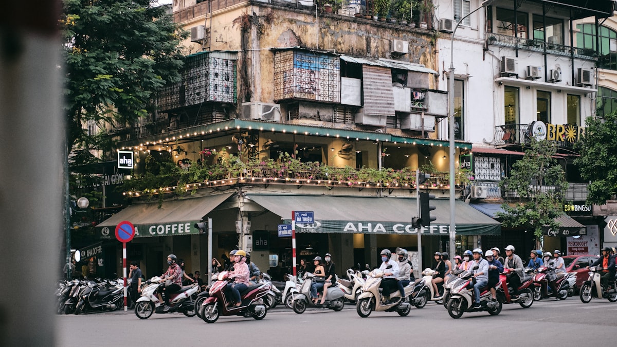 Hanoi March — motorcycles and scooters weaving through the streets of the Old Quarter in spring