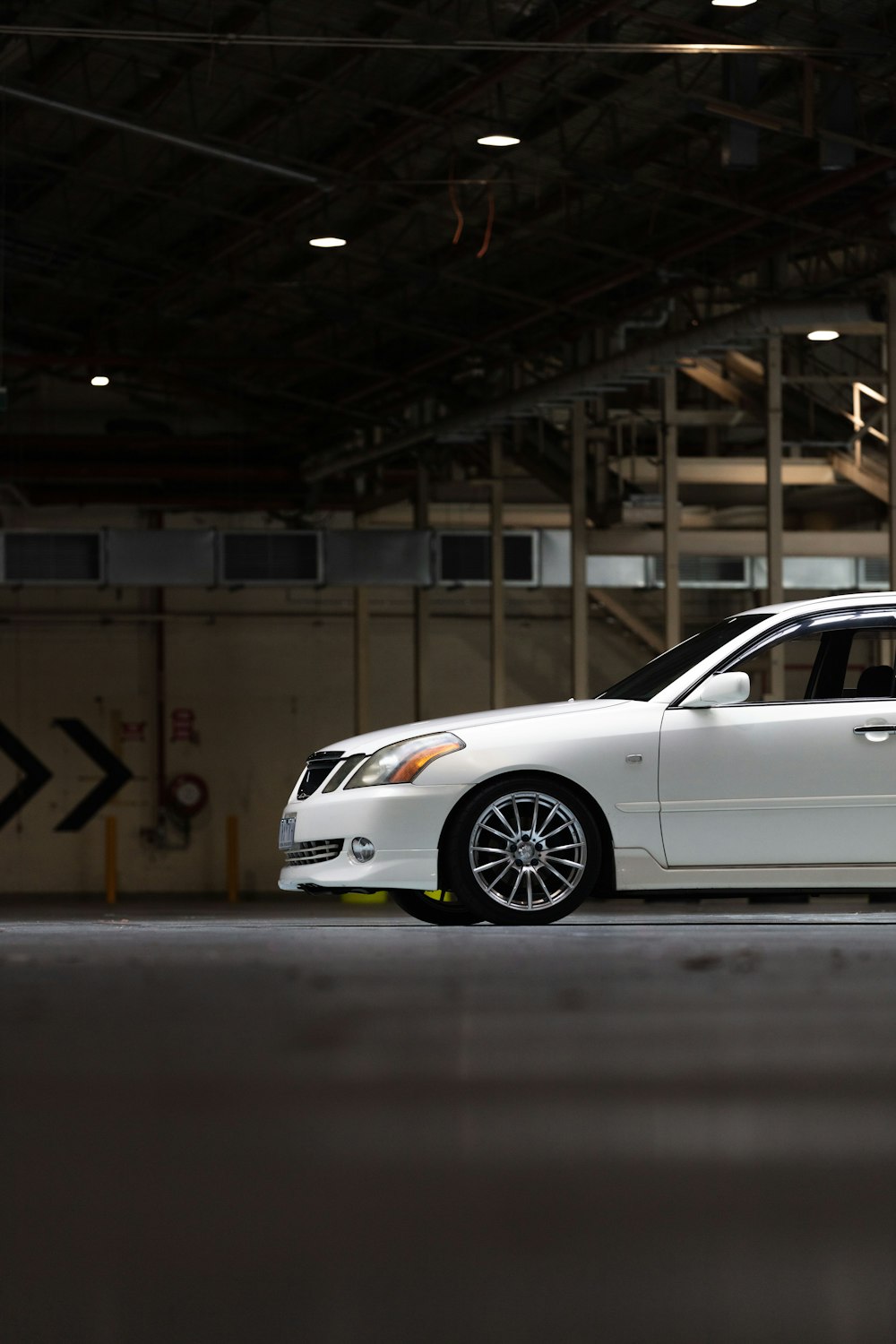 white coupe on a parking lot