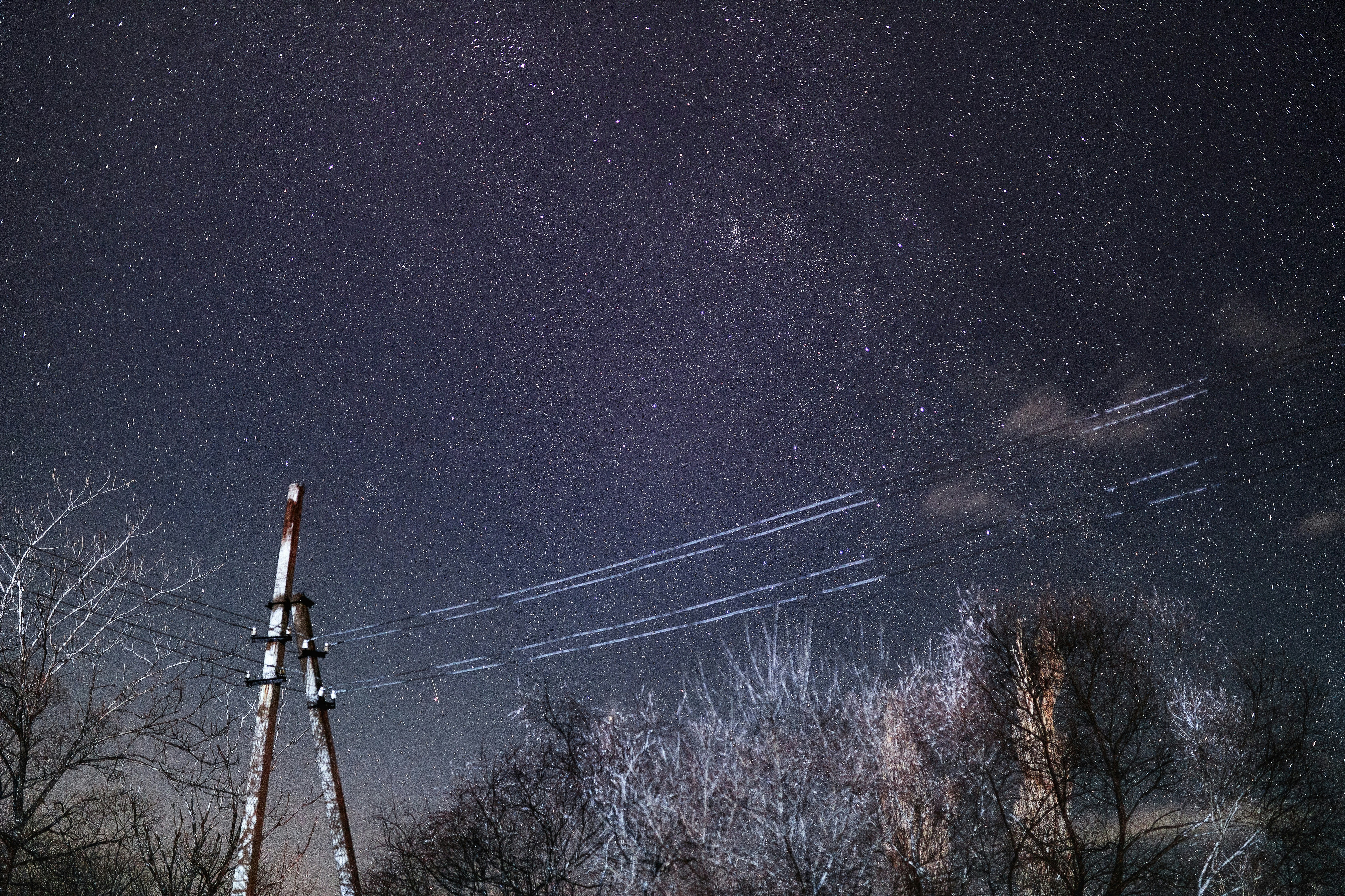 the night sky is full of stars and a radio tower