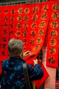 A team member setting up a vibrant advertising banner on a storefront.