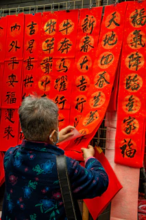 Close-up of hands setting up a promotional banner at a local business.