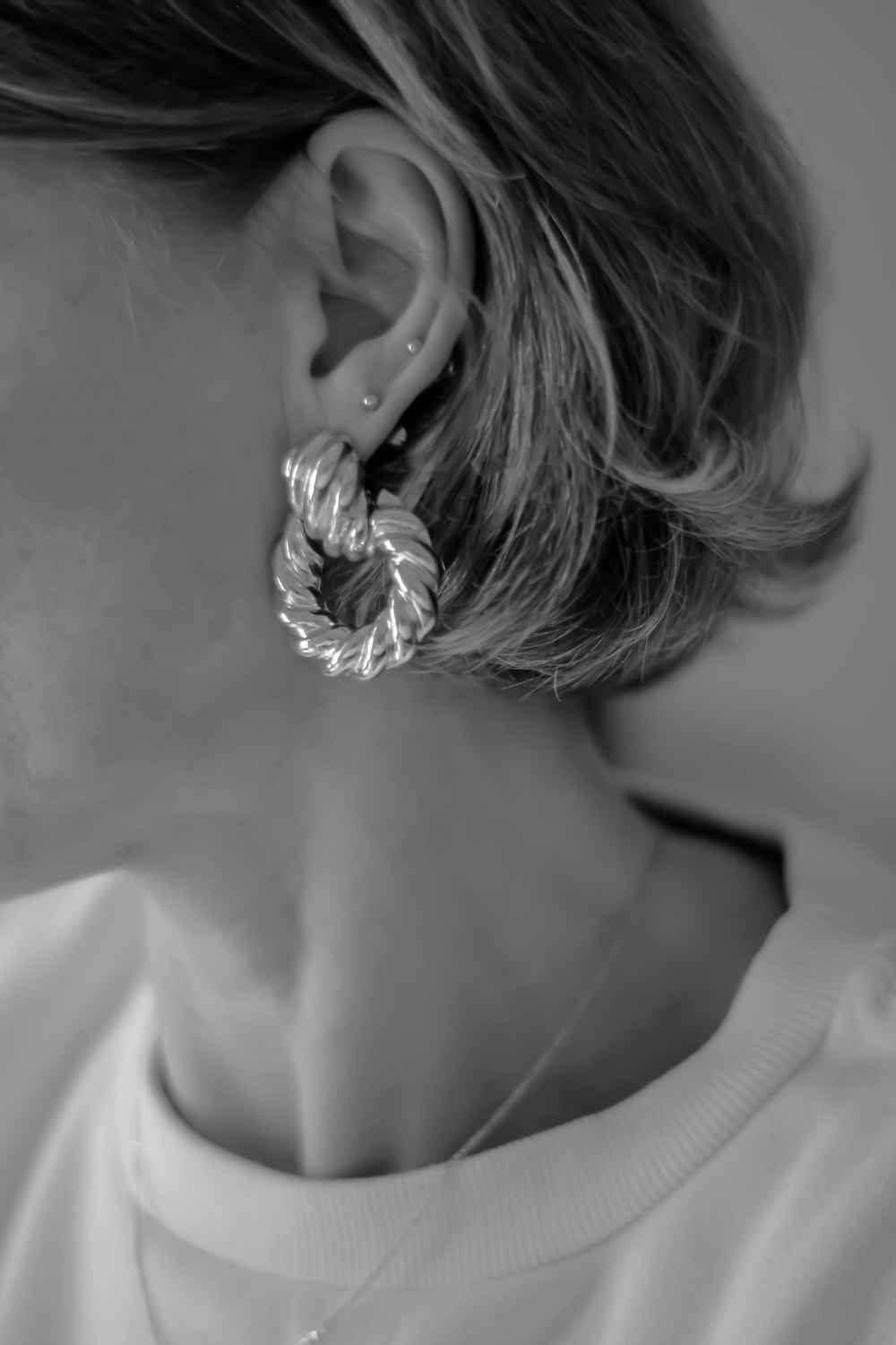 grayscale photo of woman wearing white shirt