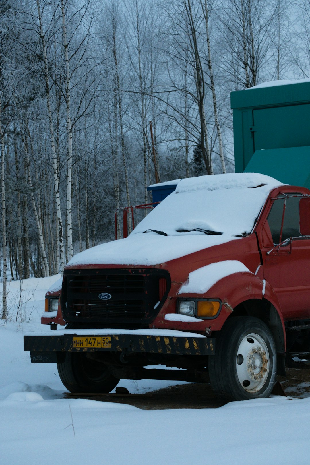 red chevrolet truck on snow covered ground during daytime