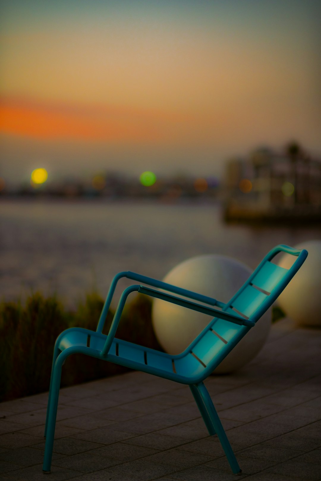 blue and white chair on green grass field during sunset