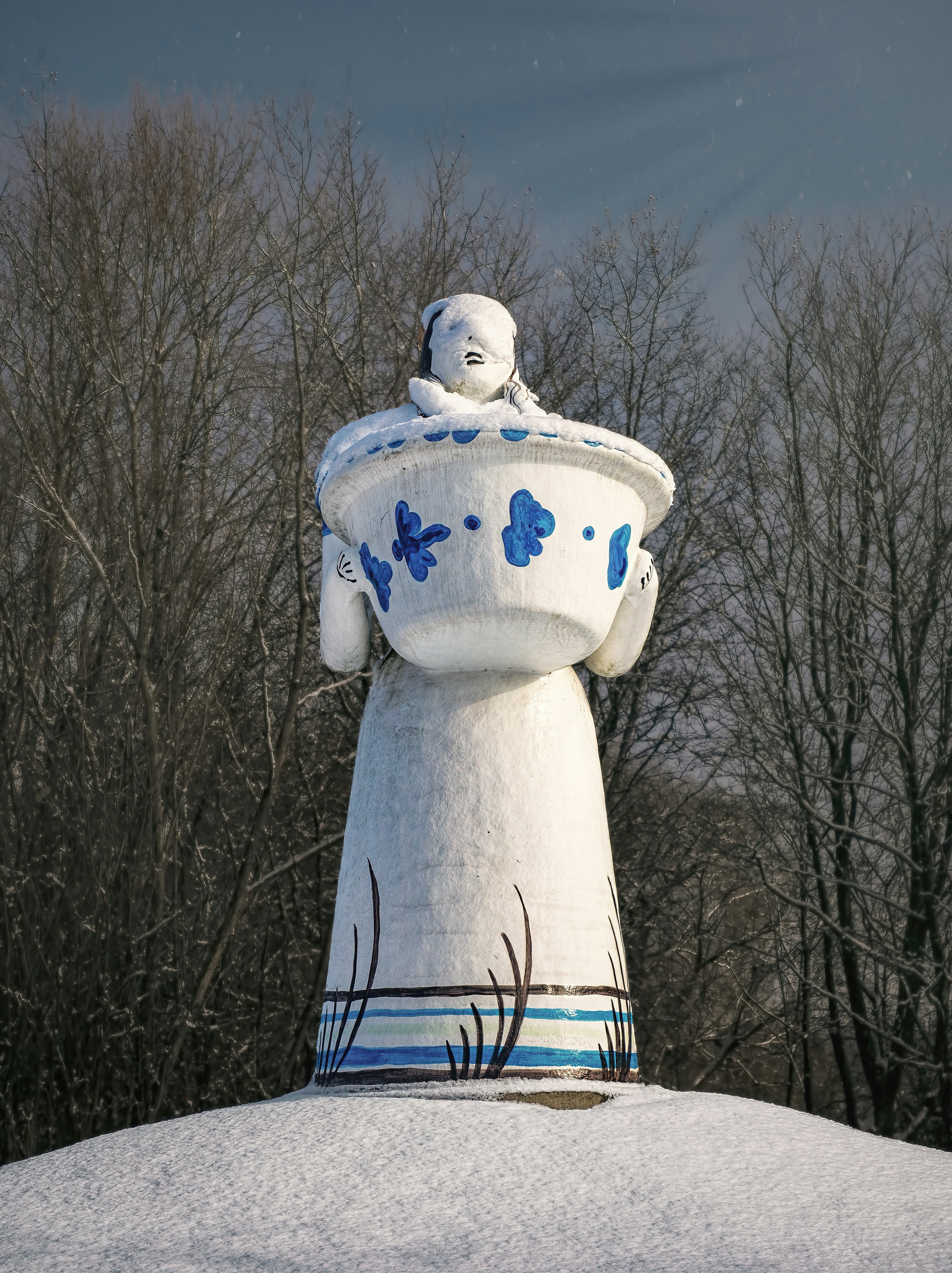 white and blue ceramic snowman