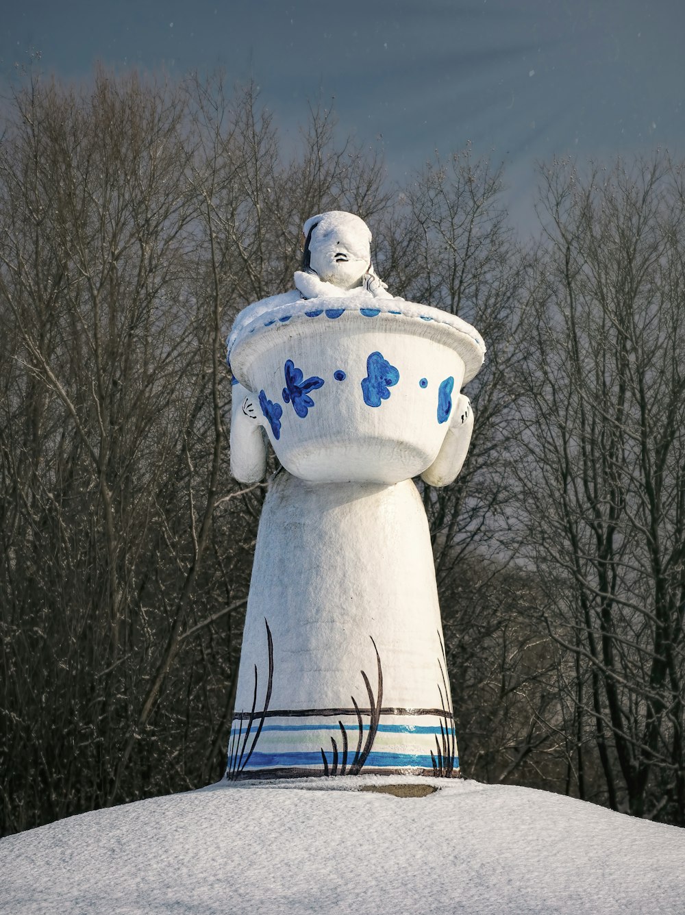 white and blue ceramic snowman