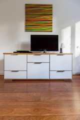 black flat screen tv on white wooden cabinet